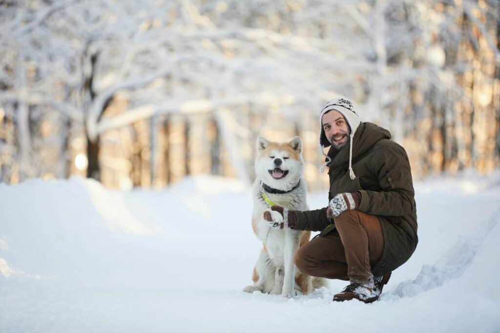 Man Posing With Akita Dog
